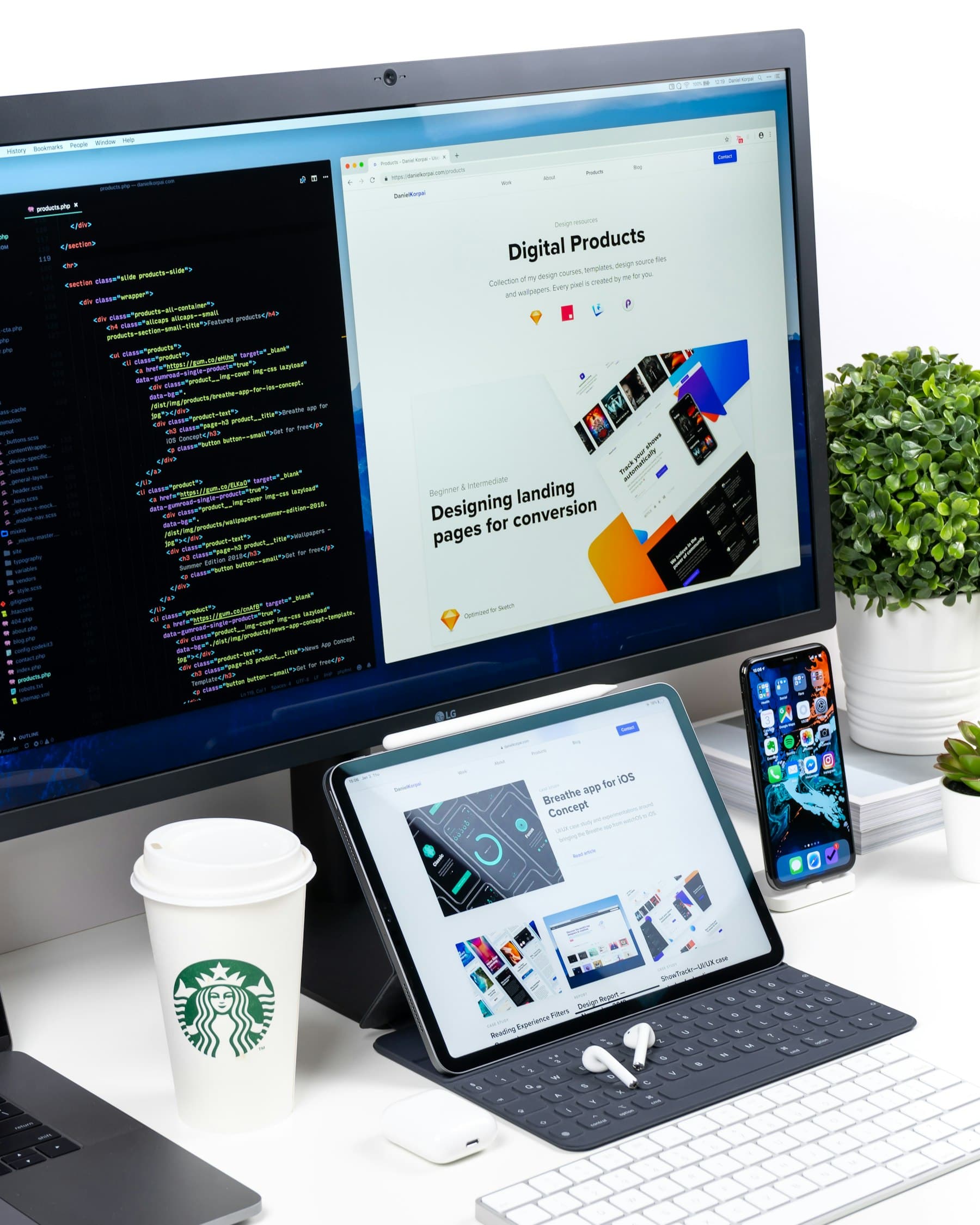 A finished website design open across desktop, tablet and phone on a designer's desk